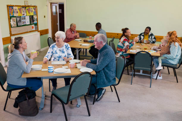 Older adults sharing a table over coffee and a meal with visitors